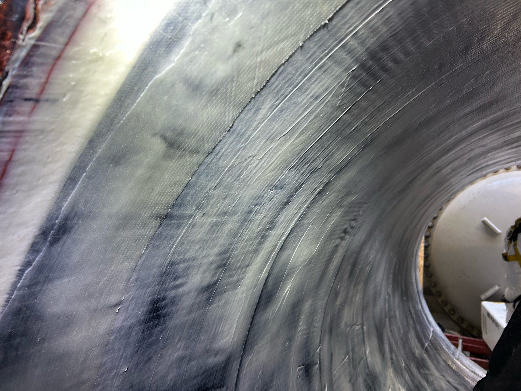 Protective lining being applied inside a large-diameter pipe