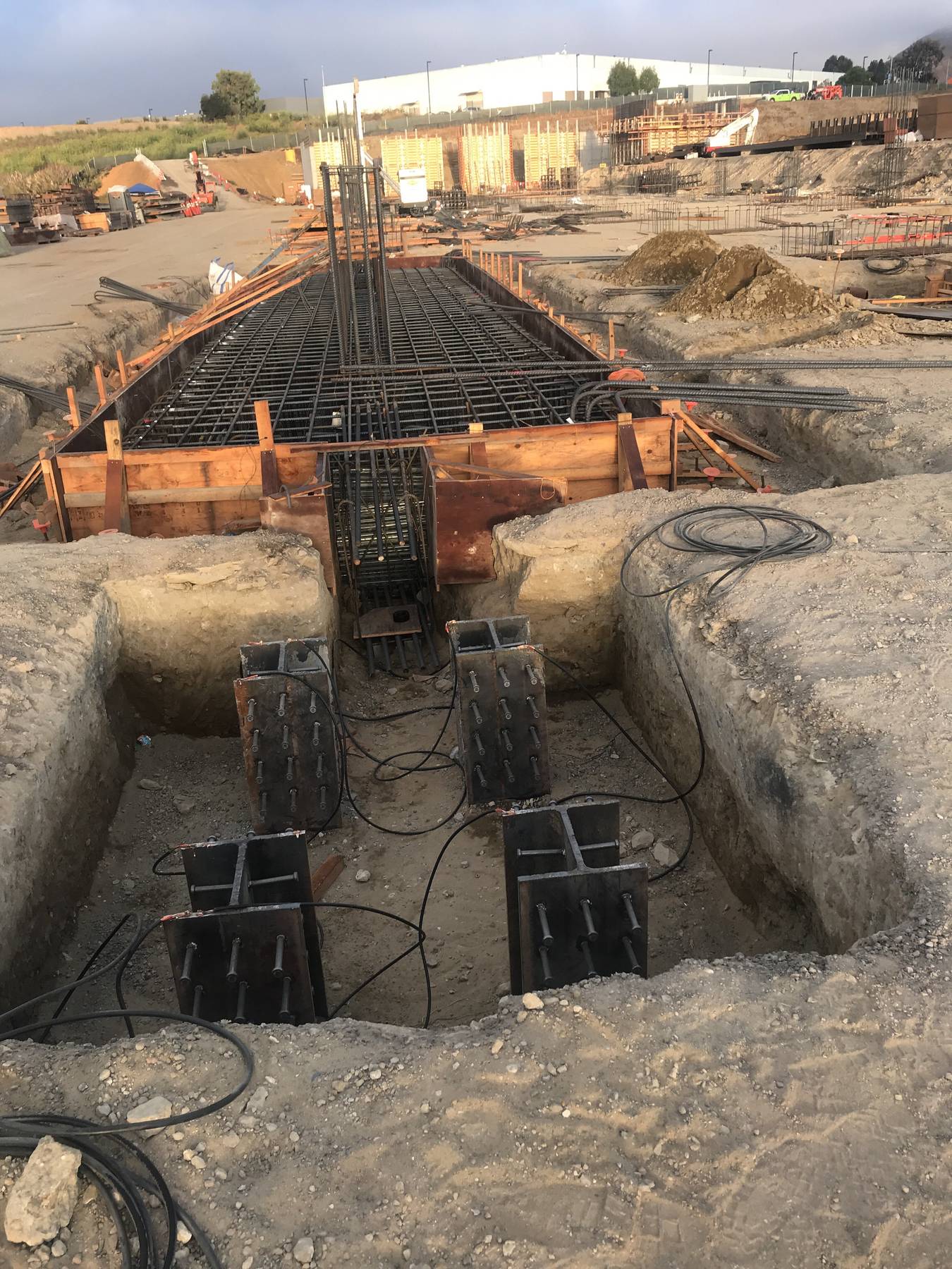 Excavation with rebar formwork and steel assemblies in a pit