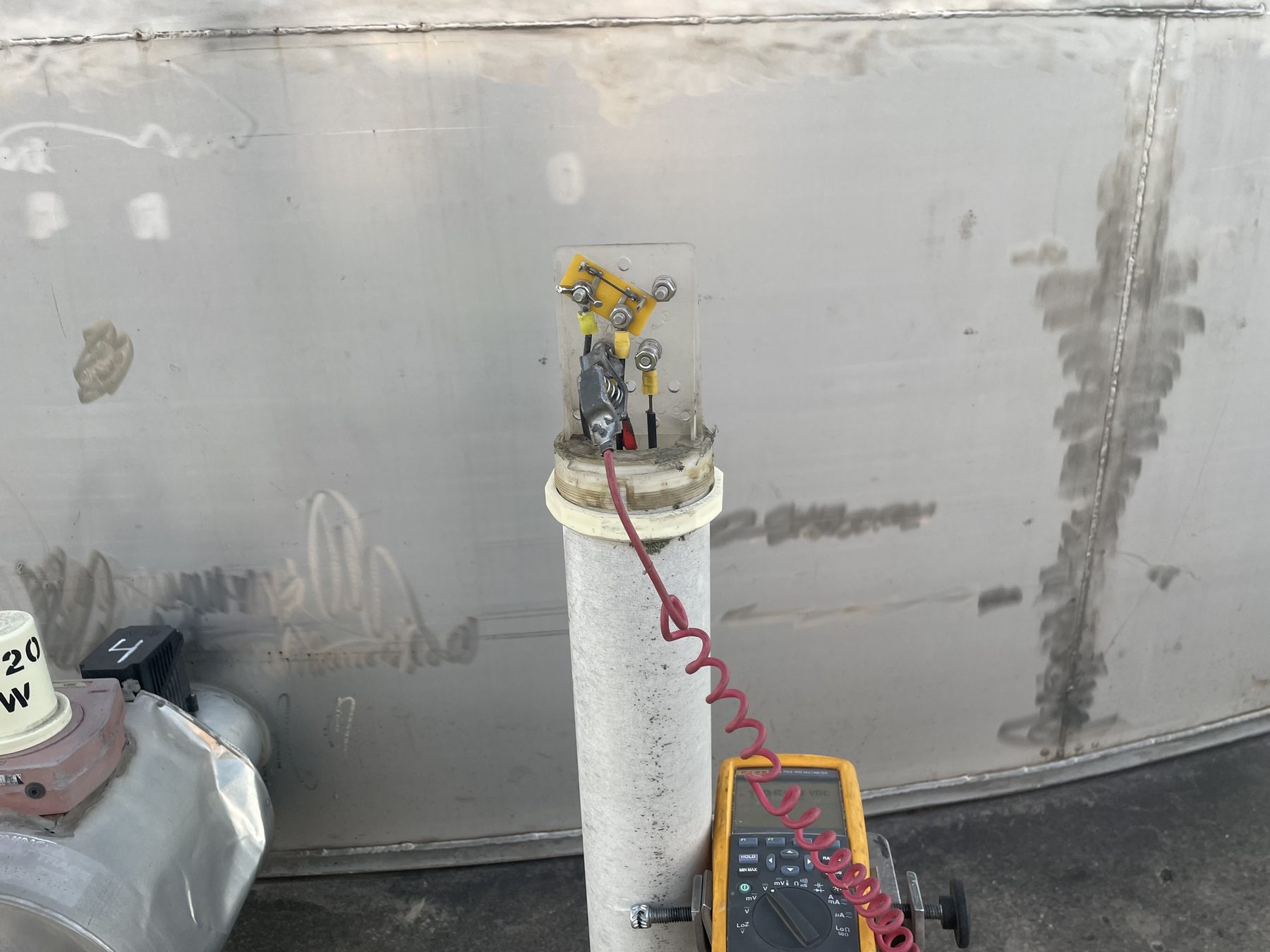 Cathodic protection test station and digital meter on a steel storage tank