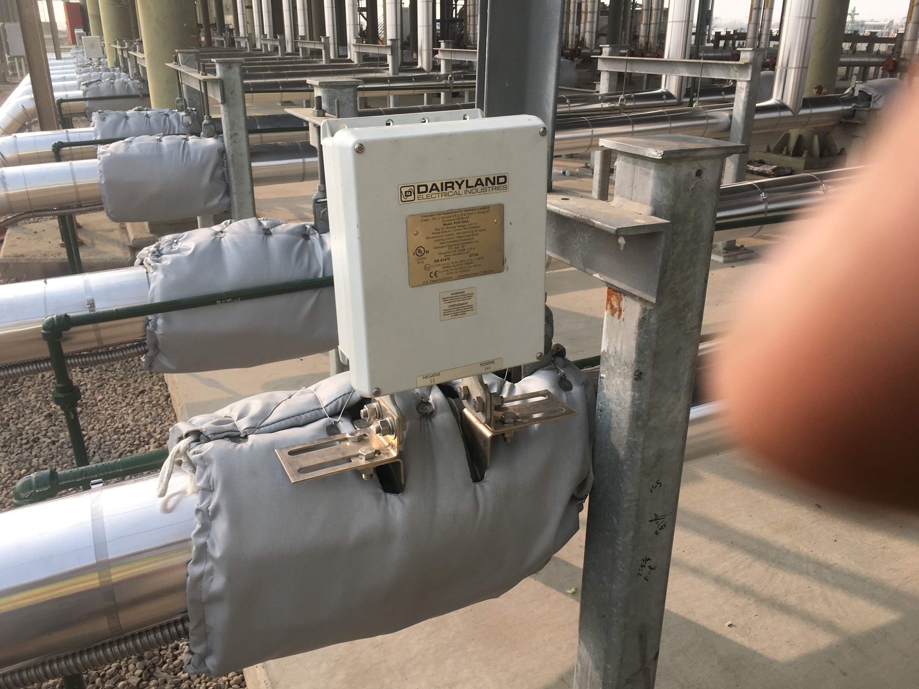 Electrical enclosure mounted on an insulated pipe.