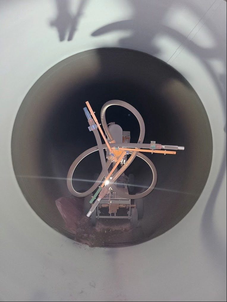 Wheeled robotic machine inside a large-diameter pipe