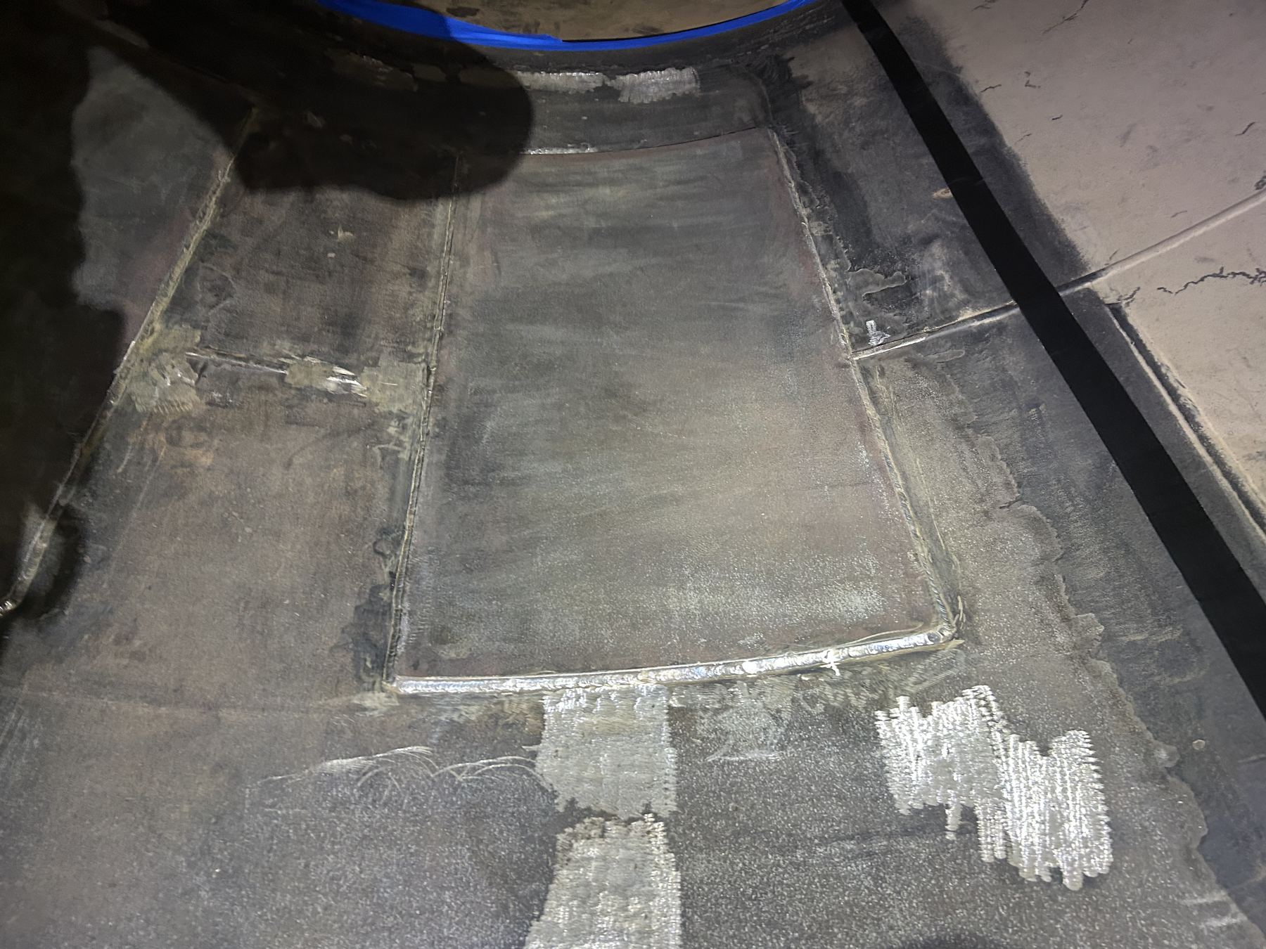 Welded repair patch on the interior of a steel vessel